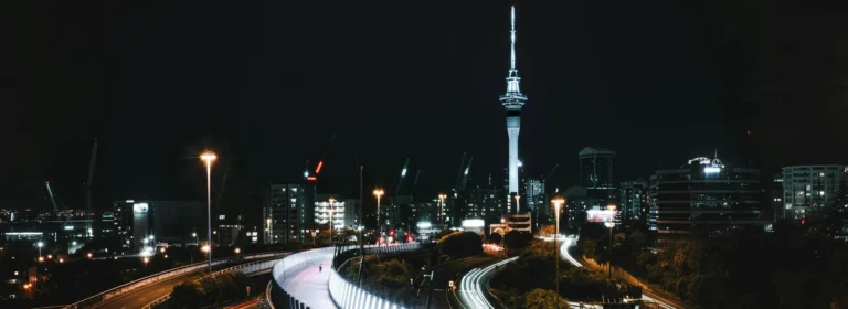 Auckland skyline at night with Sky Tower and motorway light trails, New Zealand cityscape