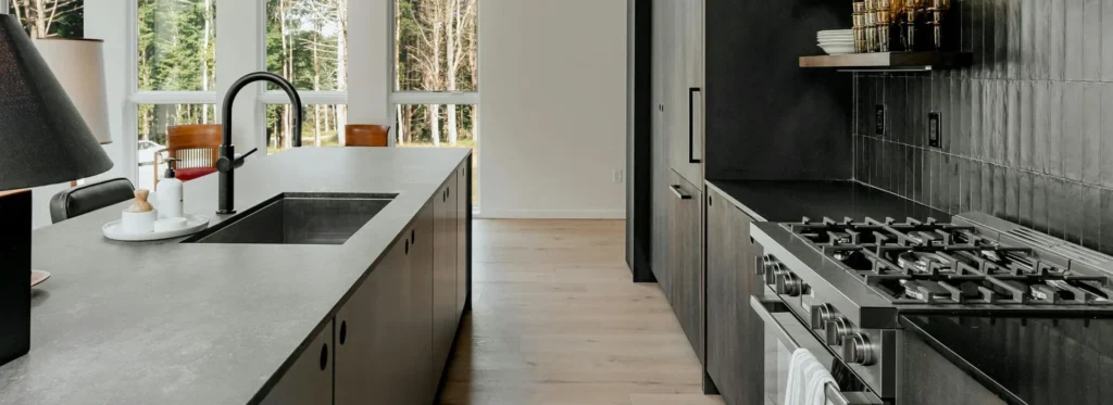 Modern kitchen with island bench and black cabinetry in contemporary New Zealand home