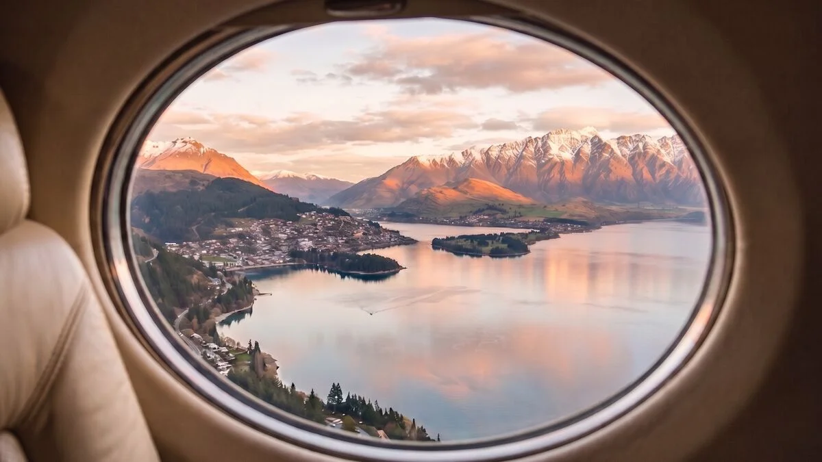 Queenstown, Lake Wakatipu and the Remarkables at first light, seen through an aircraft window on approach