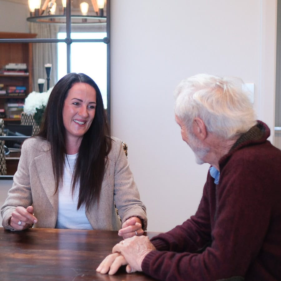 Tamzin Stevenson Buyers Agent talking to client while sitting at a table