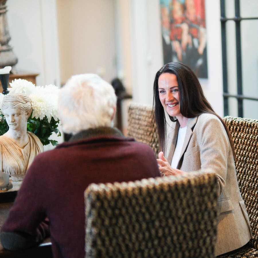 Tamzin Stevenson Buyers Agent talking to client while sitting at a table