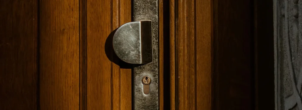 Close-up of door lock on wooden door, symbol of home ownership and property security